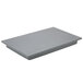 A grey rectangular plastic well cover on a table.