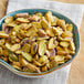 A bowl of raw pistachio halves on a table.