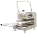 A DoughXpress stainless steel pizza dough press with a handle.
