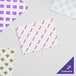 A customizable white basket liner or deli wrap sheet with various printed designs.