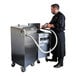 A man in a black chef's uniform using a VITO fryer oil filter machine.