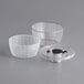 A clear plastic bowl with a white basket and a black lid.