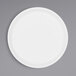 a white plate on a gray surface