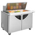 A Turbo Air sandwich prep table with a stainless steel top and wheels.