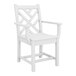A white dining arm chair with a geometric backrest design and armrests.