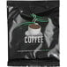 A black package of regular coffee filters with a white cup of coffee on the front.