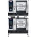 A Rational double deck liquid propane combi oven with two open doors.