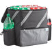 A black and gray Choice insulated cooler backpack holding soda cans and a green plastic bottle.