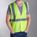 A person wearing a lime yellow Ergodyne safety vest.