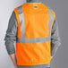 An orange Ergodyne safety vest with reflective stripes.