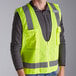 A man wearing a yellow Ergodyne surveyor vest.