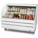 A white Turbo Air Slim Line horizontal refrigerated display case full of food and drinks.