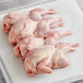 Manchester Farms fresh butterfly cut quail on a white surface.