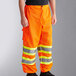 Ergodyne GloWear 8911 orange pants with yellow reflective stripes.