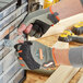 A person wearing Ergodyne ProFlex heavy-duty work gloves fixing a screw.