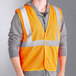 A person wearing an orange Ergodyne reflective vest.
