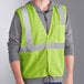 A man wearing an Ergodyne lime green reflective mesh safety vest.