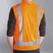 An Ergodyne orange surveyor vest with reflective stripes on a person.