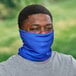 a man wearing a blue scarf over his face