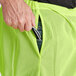A person holding a pair of Ergodyne GloWear high visibility pants.