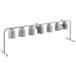 A white metal rack with seven silver heat lamps on it.