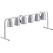 A white metal rack with six silver heat lamps on it.