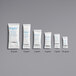 A row of small white Multisorb StripPax desiccant packets with blue text.