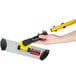 A hand holding a yellow and black Rubbermaid Quick Connect Microfiber Mop Frame.