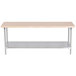 An Advance Tabco wood top work table with a stainless steel base and undershelf.