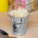 An American Metalcraft mini galvanized pail filled with coleslaw on a table.