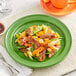 An Acopa Capri green stoneware plate with meat and vegetables on it.