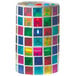A Sterno mosaic candle holder with a candle inside, featuring a green and yellow mosaic pattern with a white border.
