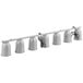 A row of silver ServIt heat lamps with white wires hanging from a white suspension bar.
