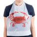 A woman wearing a white disposable poly crab bib with a red crab on it.