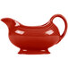 A red ceramic Fiesta sauce boat with a handle.