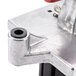 A close up of a Vollrath Redco metal device with a red button.