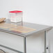 An Advance Tabco stainless steel work table with an open base.