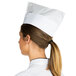 A woman wearing a Royal Paper white paper overseas cap.