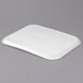 A white rectangular Huhtamaki Chinet molded fiber tray on a gray surface.