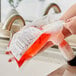 A person holding a bag of Kutol Health Guard hand soap over a counter.