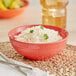 A Coral Reef stoneware nappie bowl filled with rice on a table with chopsticks.