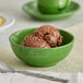 A palm green Acopa Capri stoneware bowl filled with chocolate ice cream.