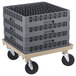 A beige Vollrath plastic dolly base for glass racks on a cart.