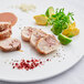 A plate with a close-up of a piece of Big Pop's Whole Alligator meat with spices on it.