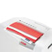 A white paper being shredded in a HSM ShredStar X6pro shredder.