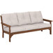 A POLYWOOD teak sofa with white cushions.