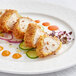 A plate with Alligator meat and vegetables on a table.