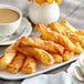 A plate of cinnamon sugar pastries with a cup of tea.