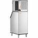 A large rectangular stainless steel Manitowoc air cooled ice machine with a black handle.