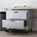 A stainless steel undercounter refrigerator with 2 drawers.